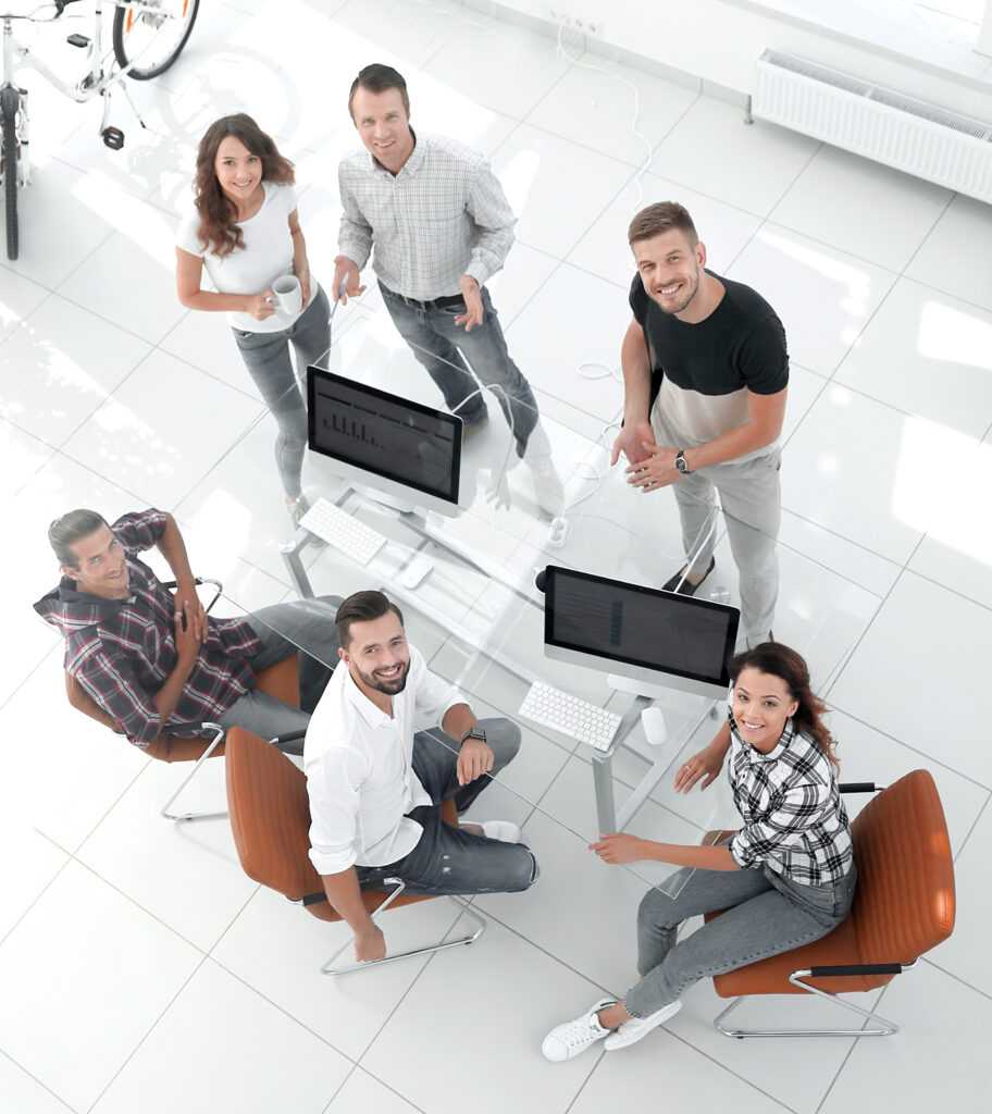 view the top creative team sitting behind a Desk